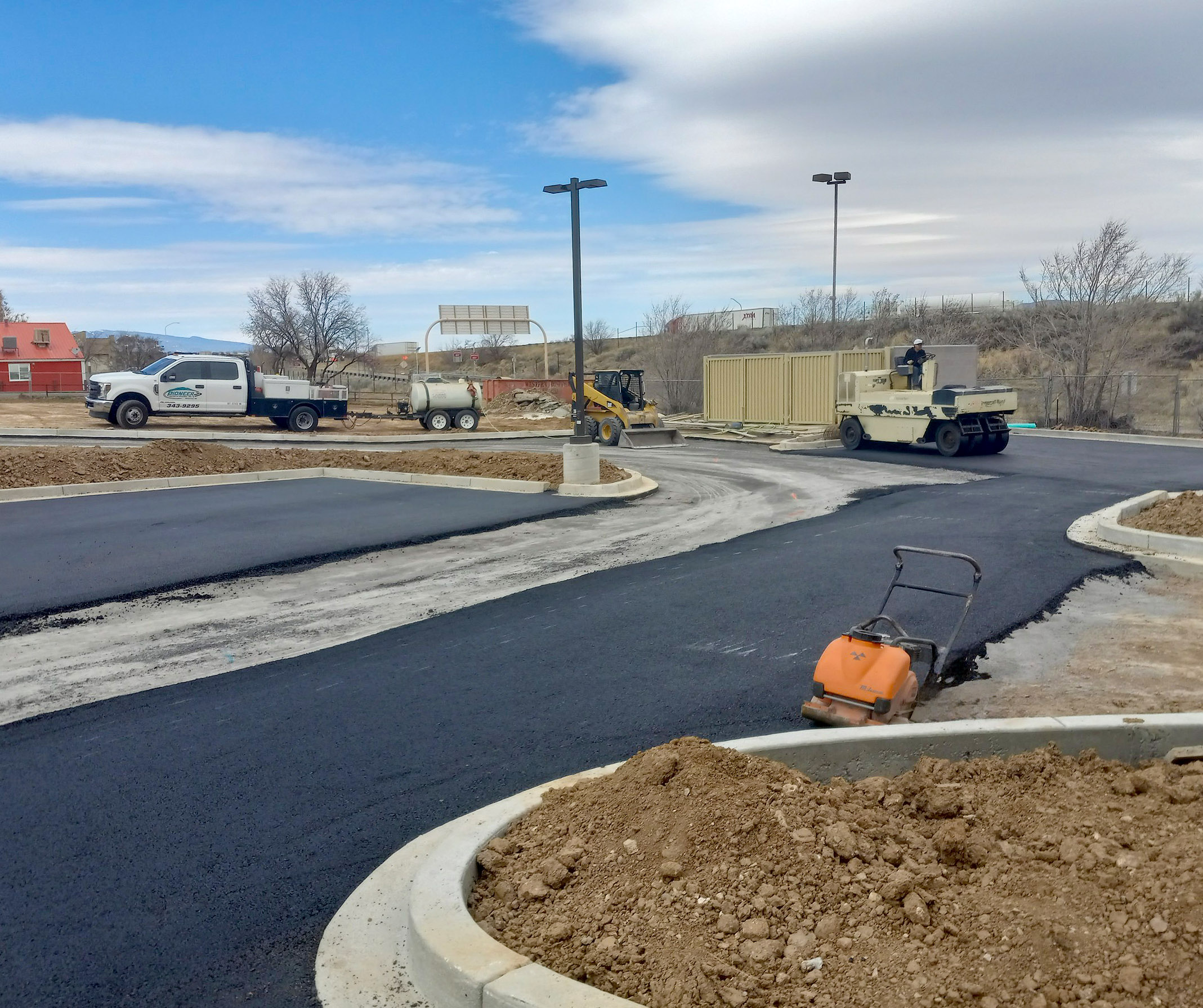 A parking lot in Moriarty, New Mexico being paved by Pioneer Paving and Grading Inc.